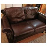 Brown leather love seat