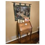 Solid oak secretary desk with drop front lid and decorative carvings on front