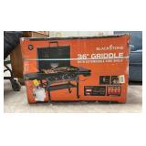 Blackstone 4 burner liquid propane outdoor griddle with hood in black