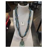 Beaded and string necklace with blue gem stone