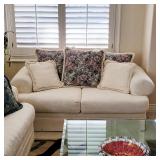 Comfy sofa, glass top table, cranberry art glass bowl