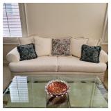 Comfy love seat, glass top table, cranberry art glass bowl