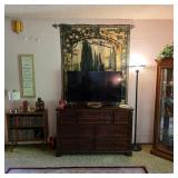 Flat screen TV, dresser, wall tapestry