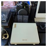 Vintage typewriter, computer speakers with subwoofer