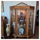 Gorgeous antique lighted curio cabinet with antiques and collectibles