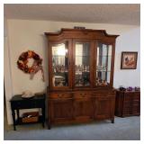 Ethan Allen table, Pennsylvania House china cabinet filled with Hummel figures