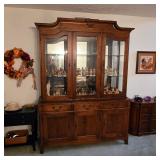 Pennsylvania House china cabinet filled with Hummel figurines