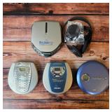 Vintage portable CD players, including a Sony Discman with the original headphones, manuals, etc.