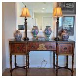 Antique sideboard with Asian porcelain, Chinese decorative vases, vintage lamps, and collectible hom