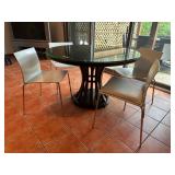 Sleek round glass dining table with scul