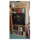 tv, entertainment center, lots of books