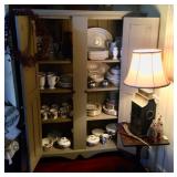 Primitive cabinet filled with Lenox Christmas china