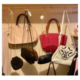 Lots of purses and handbags, many designer lables