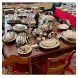 Table full of just washed silver serving pieces