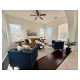 Blue velvet club chairs, rug, plants