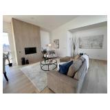 Modern rug, sofa, round iron coffee table, wall art