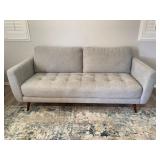 Mid Century Style Gray Upholstered Sofa With Tufted Seat And Tapered Wood Legs. Sofa Was Purchased New From Living Spaces And Is In Like New Condition.