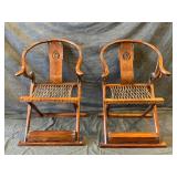 Exceptional Pair Of Antique Chinese Horseshoe Back Folding Arm Chairs With Leather Roped Seats, Carved Detailing And Metal Accents. Retains A Wax Customs Seal.