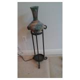 Pottery vase in stand