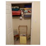 inside closet is homemade quilts and drying rack
