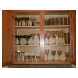 Lots of glasses in cabinet