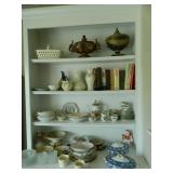 Shelves filled with nice glassware and books