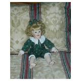 Pretty little porcelain doll that is signed