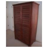 Tall wardrobe with louvered doors