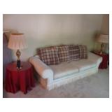 Sofa with plaid pillows and bullion fringe