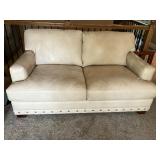 Cream leather loveseat w brass tack trim