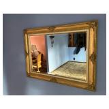Bevelled glass mirror in gilded frame