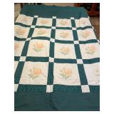 Quilt top with cross-stitched flowers