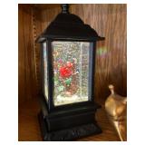 Cardinal inside lighted snow lantern