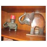 Many different elephant figurines made out of several different medias.