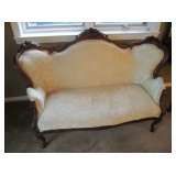 Victorian settee with carved roses and ivory, gold and green flowered upholstery.  Really pretty.
