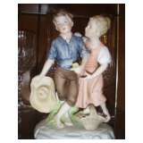 Bisque handpainted boy with straw had with girl and basket.