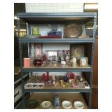 1st shelf plates, crystal, silver platter 2nd shelf vases, glassware 3rd shelf $0.50-$1 items 4th sh