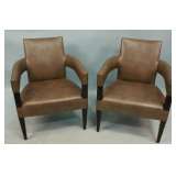 pair of leather upholstered arm chairs