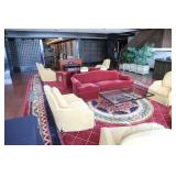 red sofa, upholstered side chairs, glass coffee tables 