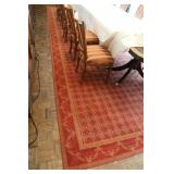 red rug and dinning table and chairs 