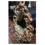 Carved framed mirror with figures