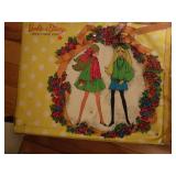 Has dolls and lots of clothes.