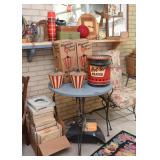 Table with Wrought Iron Legs, Vintage Outdoor Torches, and "Hot-ter Heater"