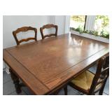 Antique Expandable Carved Oak Dining Table & 4 Chairs with Rattan Seats