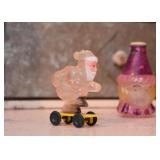 Vintage Celluloid Santa Claus on Wheels / Skateboard Christmas Toy