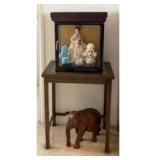 APM016 - WOODEN TABLE, WOODEN ELEPHANT DECOR & AN ANTIQUE JAPANESE PORCELAIN DOLL.