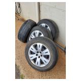 4 each Rims with P215 65R16 96h 3 Bridgestone and 1 Dueler tires. Tires are baldish. 4 Subaru hubcap