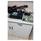  This lot includes a Xbox game system 13" x 11", with two head sets. Games included, Destiny, Guitar