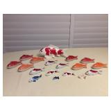 This lot contains various ceramic Koi fish figurines ranging in size of 3.25”l to 9.5”l. All are in 