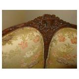 Crest of highly carved love seat